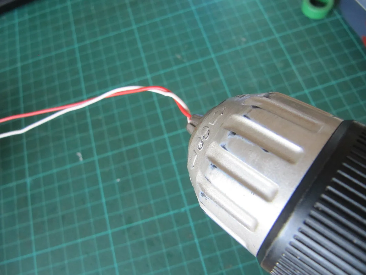 Put the other end of the pair of wires into the chuck of an electric screwdriver